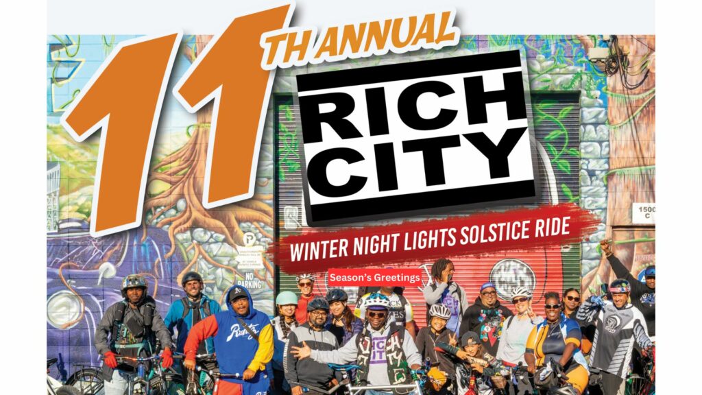 A group of people smiling and posing with bicycles in front of a mural. "11th annual RICH CITY WINTER NIGHT LIGHTS SOLSTICE RIDE - Season's Greetings"