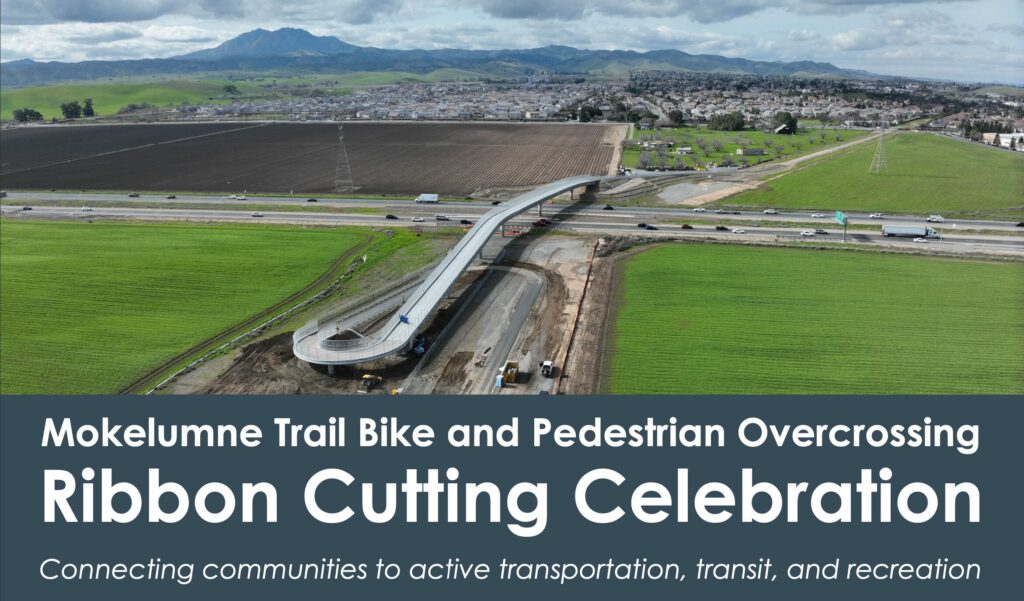 Aerial photo of the Mokelumne Trail Bridge over Hwy 4 Text: "Mokelumne Trail Bike and Pedestrian Overcrossing Ribbon Cutting Celebration Connecting communities to active transportation, transit, and recreation"
