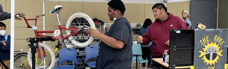 photo of a person working on a kids bike in a repair stand