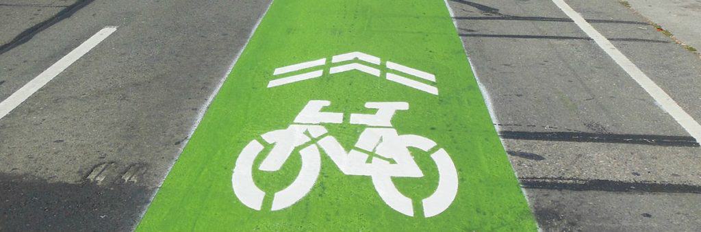 "sharrow" shared lane bicycle marking with a green painted background