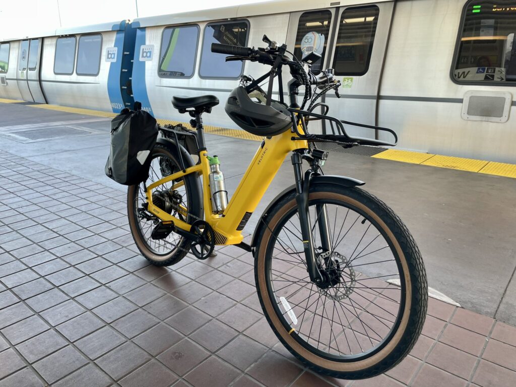 photo of an electric bicycle on a BART station platform next to a train