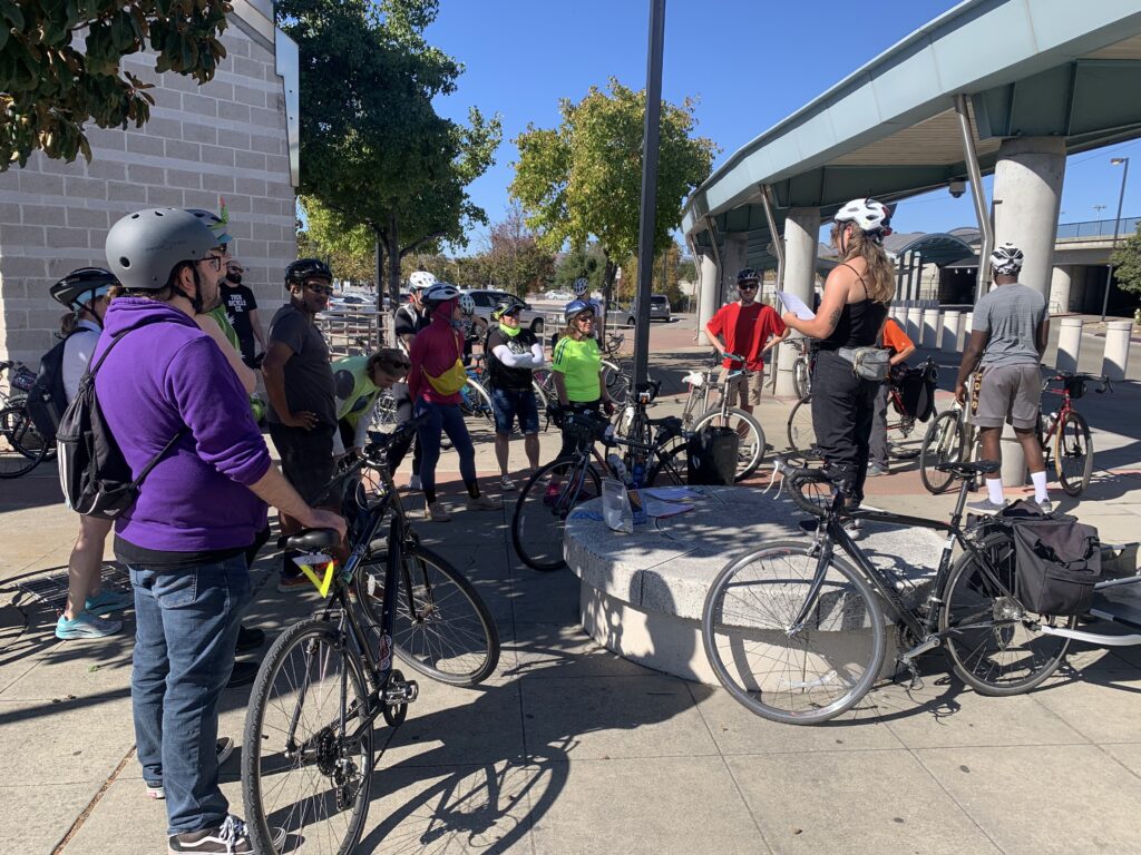 A group of bikers gather around at a BART station