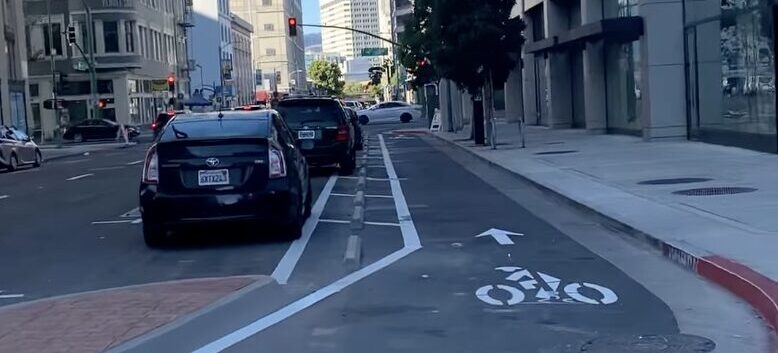 photo of parking-protected bikeway on Franklin St in Downtown Oakland